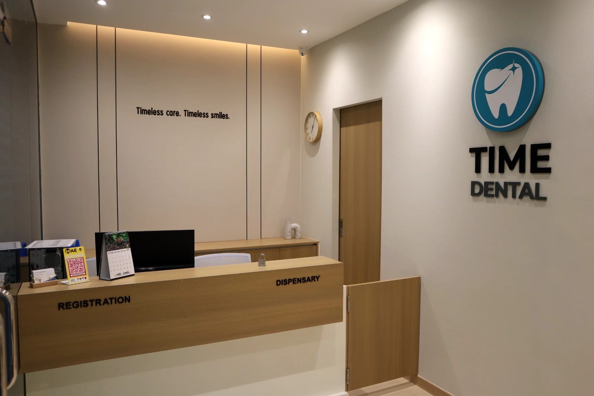 TIME DENTAL reception with warm wood finishes and clinic logo